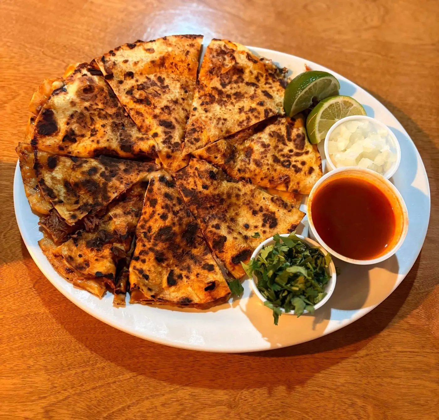 Quesa-birria with consomé, cilantro, onion and lime